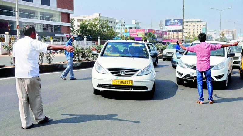 Members of the cab drivers and owners association stop taxis as part of their five-day strike.