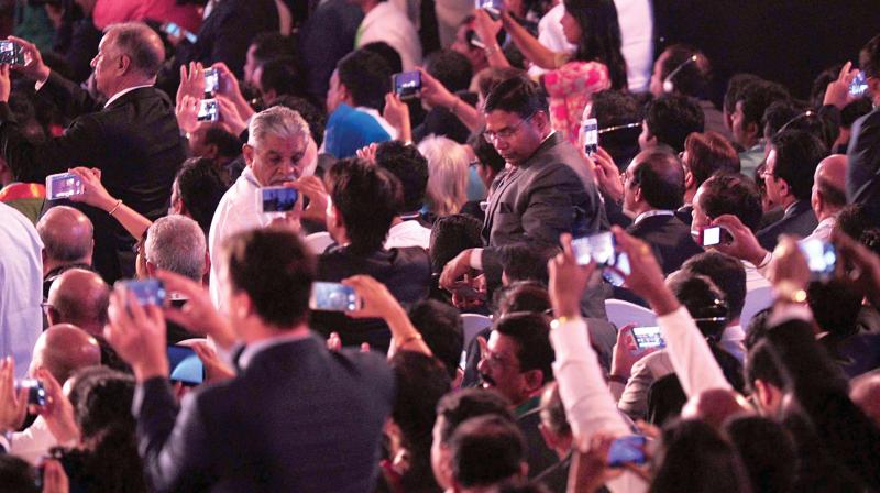 Audience click  pictures of PM Narendra Modi during his speech at Pravasi Bharatiya Divas in Bengaluru on Sunday. (Photo: R. Samuel)