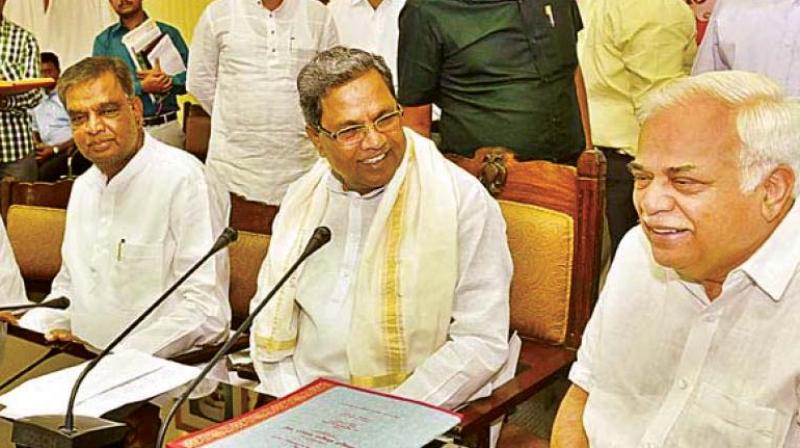 Former minister Srinivas Prasad, the BJPs candidate for Nanjangud, with Chief Minister Siddaramaiah in a file photo
