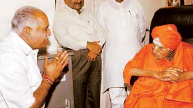 The tallest political leader of the Lingayat community and former CM B.S. Yeddyurappa with the seer of Siddaganga Math, Shivakumara Swamiji in a file photo.