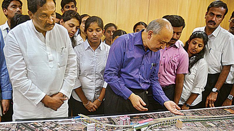 Bengaluru Development Minister K. J. George and BMRCL MD Pradeep Singh Kharola take a look at the model of Metro 2nd phase in Bengaluru on Thursday. (Photo: DC)