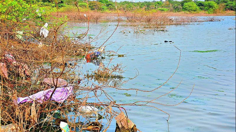 Kowkur lake, a religion site, is littered with waste.