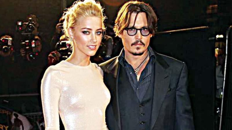 Actor Johnny Depp with ex-wife Amber Heard. The agreement called for Depp to pay Heard $7 million, which Heard has pledged to charities. (Photo: AP)