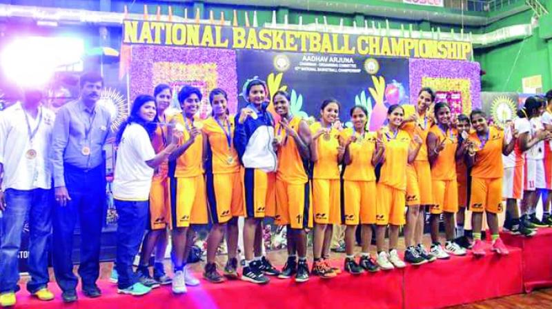 Members of the Telangana womens basketball team pose after finishing runners-up at the National Basketball Championship in Puducherry.