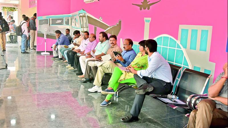 GHMC commissioner G. Janardhan Reddy (third from right) with other officials wait for K.T. Rama Rao for the inauguration of the bus stop at Hitec City on Tuesday.