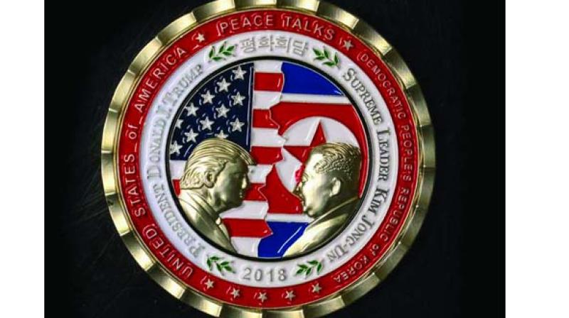 The coin depicts Trump and Kim, described as North Koreas â€œSupreme Leader,â€ in profile facing each other in front of a background of US and North Korean flags