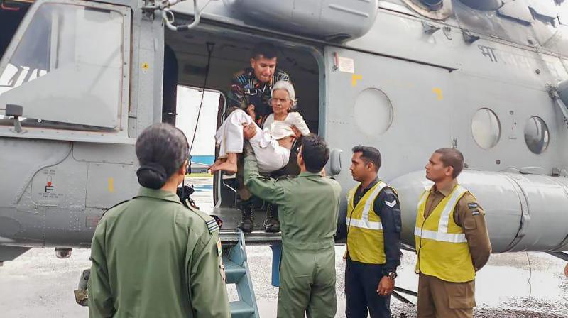 Indian Air Force members conduct rescue and evacuation drive in flood-affected regions of Kerala on Sunday. (Photo: PTI)