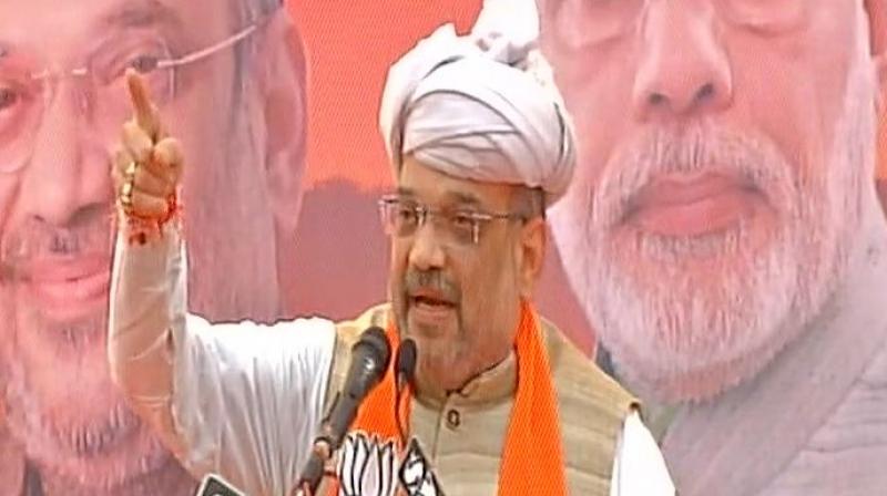 Speaking at Gujarat Gaurav Yatra in Porbandar BJP Chief Amit Shah said, Rahul always questions what Prime Minister Narendra Modi did in past three years, but I want to ask what UPA did in 10 years. (Photo: ANI | Twitter)