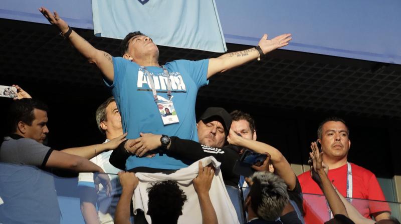 Diego Maradona appeared to need help to walk after watching his national team dramatically beat Nigeria to survive in the World Cup. (Photo: AP)