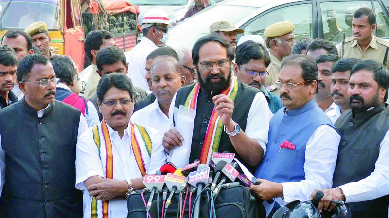 TPCC president N. Uttam Kumar Reddy addresses the media outside the Raj Bhavan after submitting a memorandum to the Governor related to sand mafia and law and order situation in the state, while other Congress leaders look on in Hyderabad on Friday. (Photo: DC)