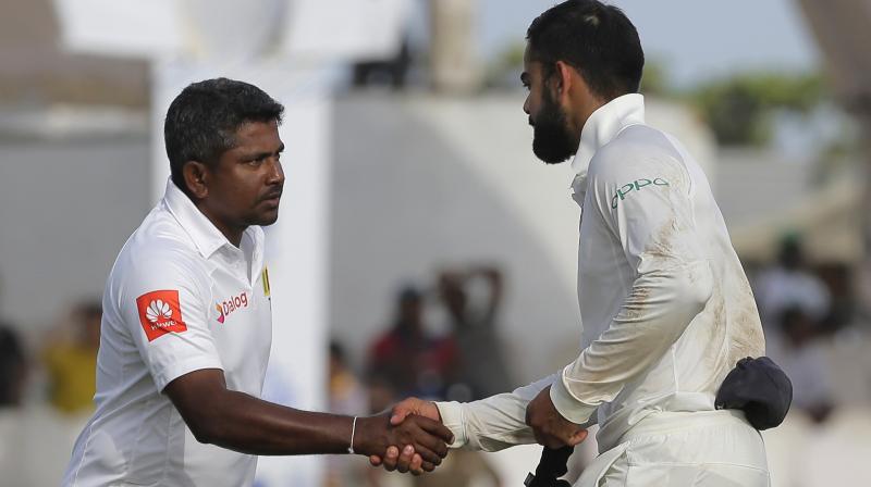 Indias captain Virat Kohli, right, shakes hands with Sri Lankan captain Rangana Herath after their win in the first test cricket match in Galle. (Photo: AP)