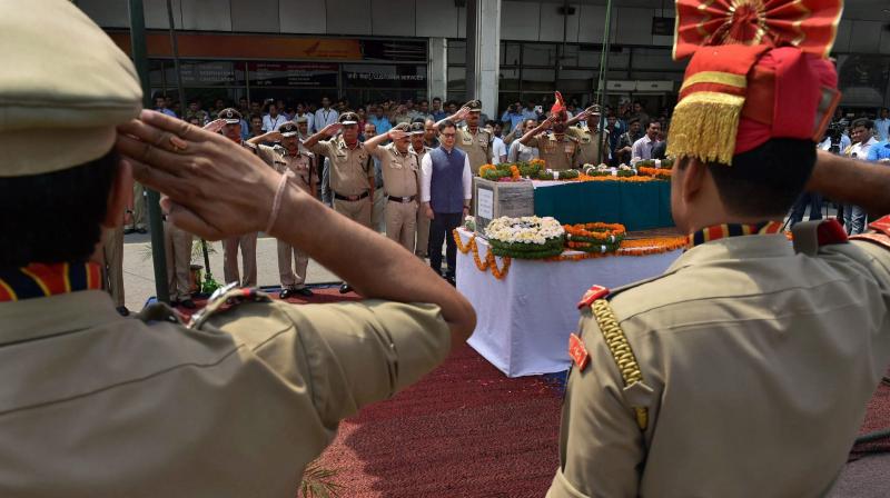 Minister of State for Home Kiren Rijiju laying a wreath at the coffin of BSF Head Constable Prem Sagar after it was brought at Palam Airport in New Delhi. (Photo: PTI)