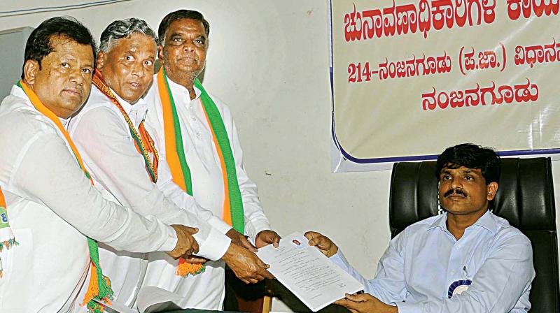 BJP candidate V. Srinivasprasad submits nomination papers for Nanjangud bypoll in the temple town on Monday.