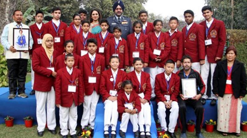 Chief of the Air Staff, Air Chief Marshal BS Dhanoa and AFWWA President Kamalpreet Dhanoa in a group photograph with children who are awardees of the National Bravery Award for year 2016 in New Delhi on Tuesday. (Photo: PTI)