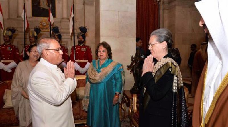 President Pranab Mukherjee exchanges greetings with Congress President Sonia Gandhi during an At Home reception organised on the occasion of Republic Day at Rashtrapati Bhavan in New Delhi on Thursday. (Photo: PTI)