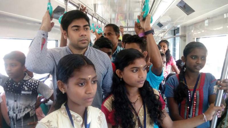 Tribal children enjoy the metro ride with Wayanad district collector S. Suhas.