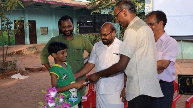 SIET director B. Aburaj distributes certificate to a participant of  film appreciation camp at Government UP School at Ramanattukara  on Sunday.