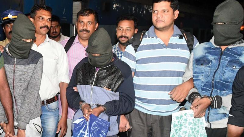 The three accused involved in the serial robbery with their faces covered being brought to Kochi on Sunday.	DC