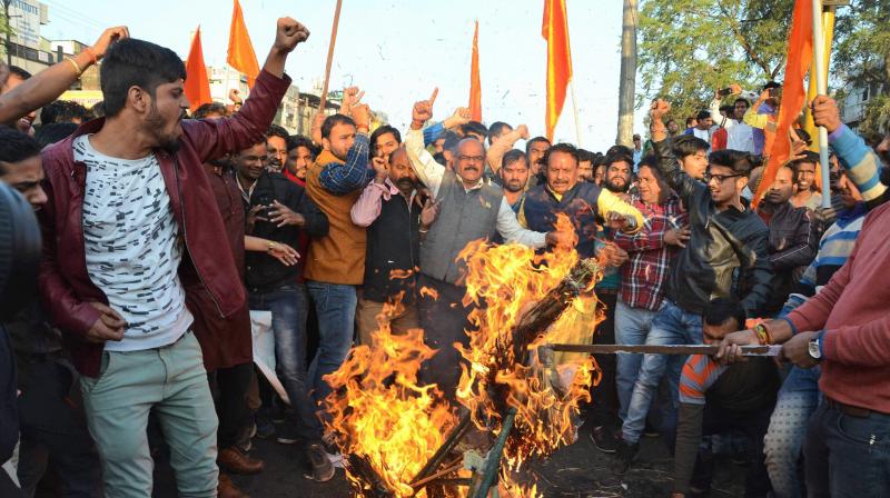 Karni Sena activists burn posters during a demonstration against the release of film Padmaavat in Bhopal on Wednesday. (Photo: PTI)