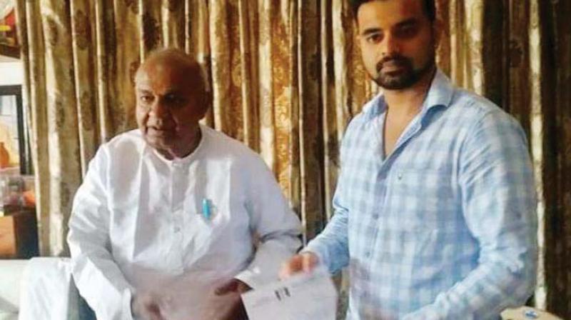 JD(S) supremo H.D. Deve Gowda with his grandson Prajwal Revanna in this file photo