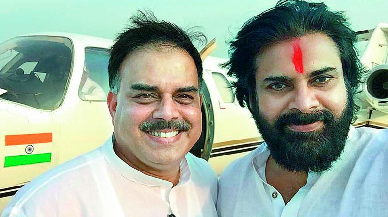 Jana Sena chief Pawan Kalyan takes a selfie with Congress leader and former speaker Nadendla Manohar at Tirupati Airport on Thursday.