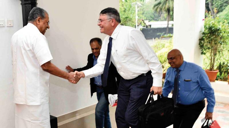 Chief Minister Pinarayi Vijayan comes out of his house to receive Fujitsu Consulting India chief executive officer Shrikant Vaze, senior director Manoj Nair and Nissan chief information officer Tony Thomas at the Cliff House on Thursday. (Photo:PRD)