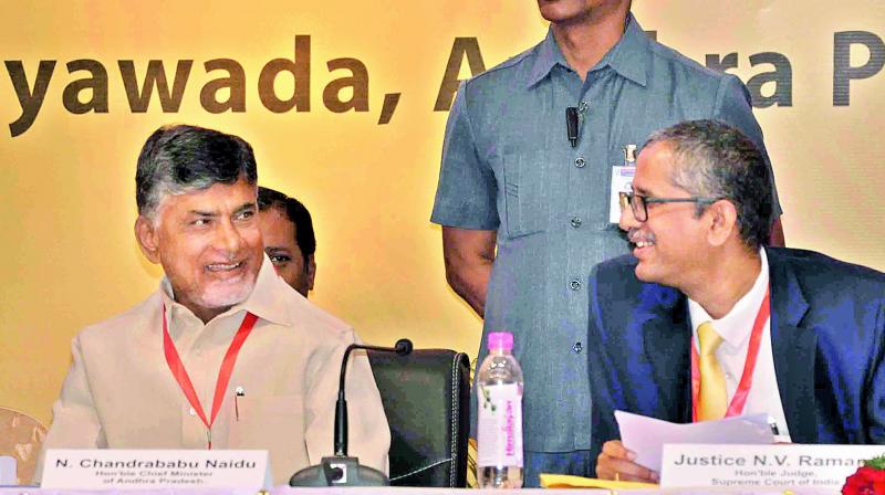 Chief Minister N. Chandrababu Naidu, Supreme Court judge N.V. Ramana share a word at the national workshop on intellectual property, commercial and emerging laws in Vijayawada on Friday. (Photo: DC)