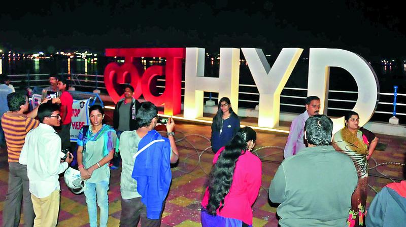 Citizens and tourists flock to the Love Hyd structure on the Tank Bund to take photos and click selfies, on Sunday. Authorities have put up special lighting to make the place more attractive.	 DEEPAK DESHPANDE