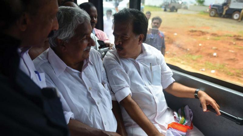 AICC general secretary Oommen Chandy and Opposition leader Ramesh Chennithala exchange views while on bus during the visit by Congress leaders to Sabarimala on Tuesday.