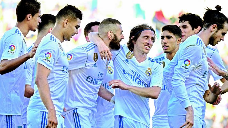 In this file picture, Karim Benzema (No. 9) of Real Madrid celebrates with his teammates after scoring his sides second goal during their Spanish league match against Las Palmas at the Gran Canaria stadium in Spain. (Photo: AP)