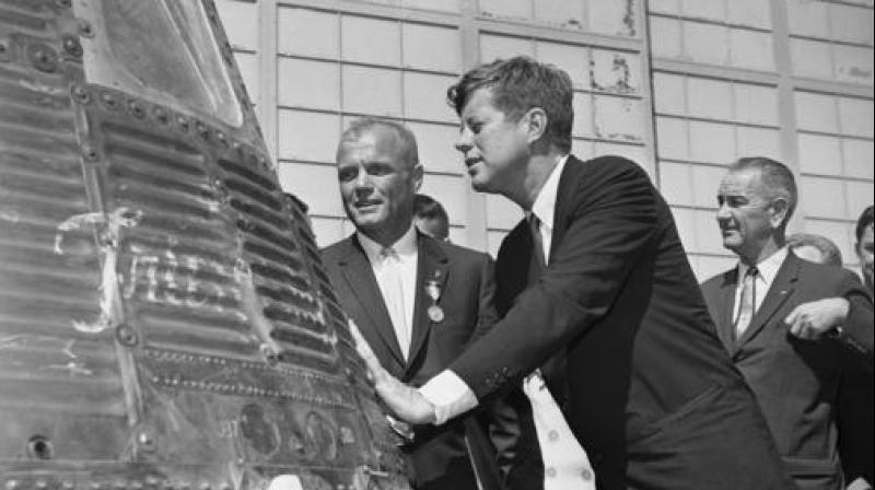 FILE - In this Feb. 23, 1962 file photo, astronaut John Glenn and President John F. Kennedy inspect the Friendship 7, the Mercury capsule in which Glenn became the first American to orbit the Earth. Kennedy presented Distinguished Service medal to Glenn at Cape Canaveral, Fla. At right is Vice President Lyndon Johnson. Glenn, who later spent 24 years representing Ohio in the Senate, has died at 95. (AP Photo/Vincent P. Connolly, File)