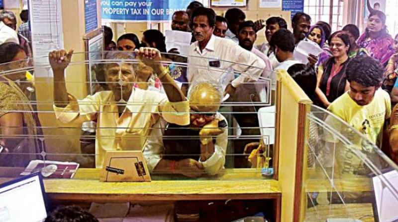 People wait for their turn to exchange demonitised currency notes at a bank. (Photo: DC)
