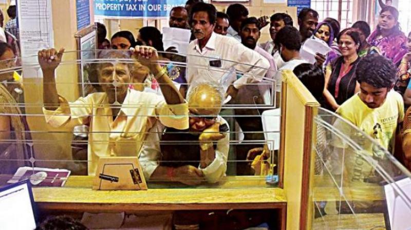 People wait for their turn to exchange demonitised currency notes at a bank in Bengaluru. (Photo: DC)