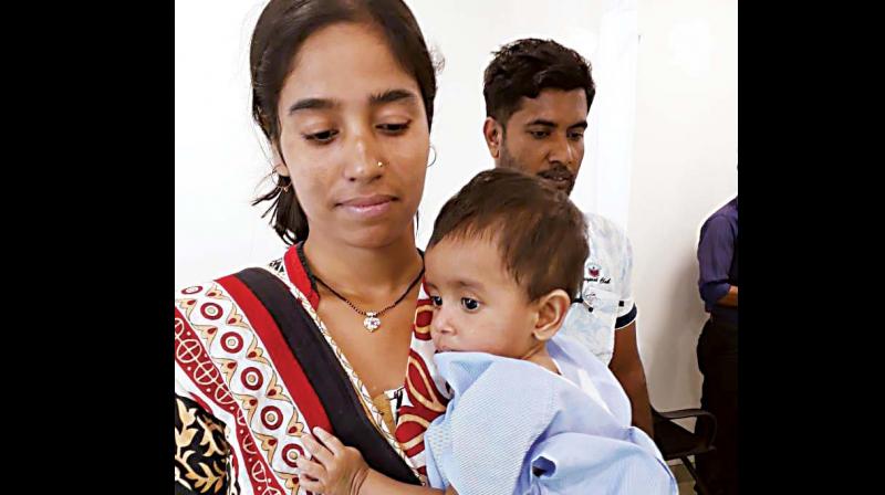 Seven-month-old Aryan with his mother.