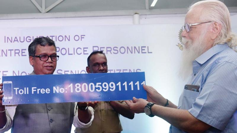 State Police Chief Loknath Behera  hands over the Toll-free number for senior citizens to former ISRO  scientist  Nambi Narayanan on Thursday DC