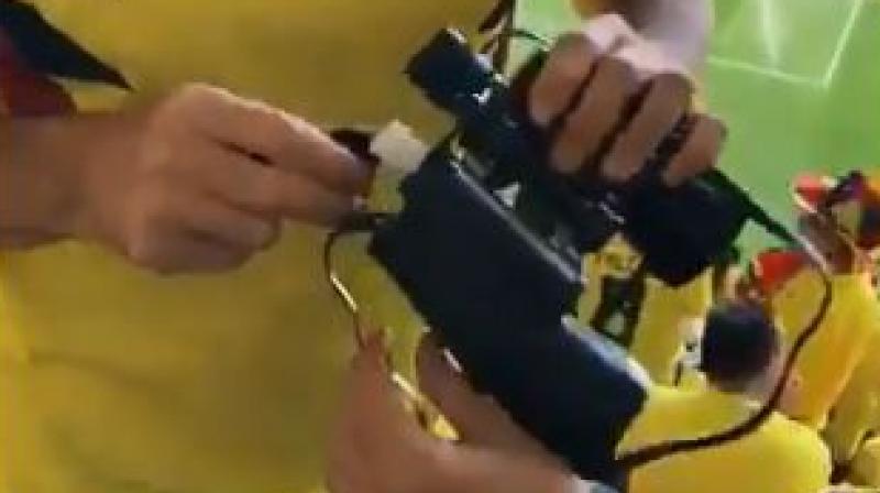 Three fans are seen drinking alcohol they smuggled into the Saransk stadium inside fake binoculars.(Photo: Screengrab)