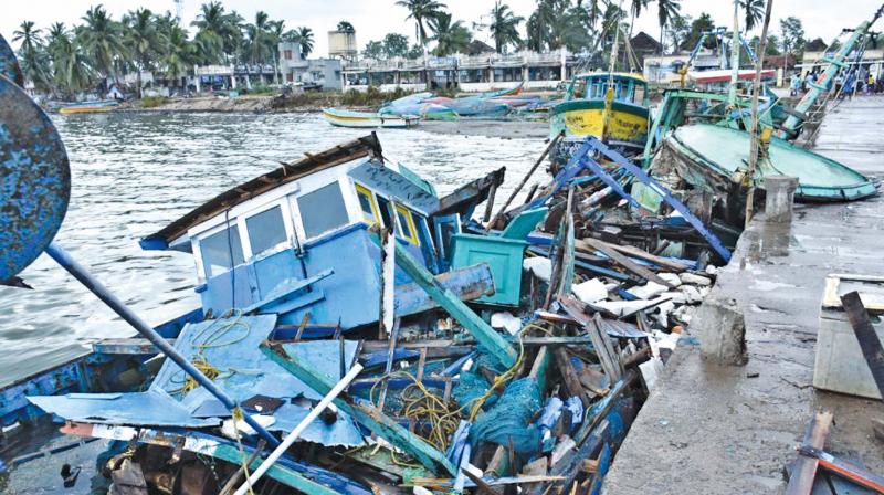 Boats that were damaged due to collision with each other during Gaja cyclone at Adhirampattinam in Thanjavur district.(Inset)damaged fishing nets. 	DC