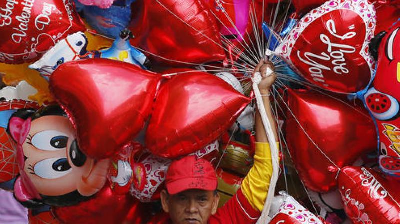 A vendor sells balloons on Valentines Day. (Photo: AP)