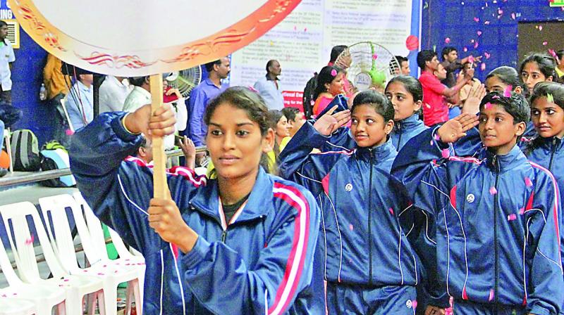 Telangana girls take the salute during the opening ceremony of the 34th Youth National Basketball Championship at the Indoor Stadium in Gachibowli, Hyderabad.