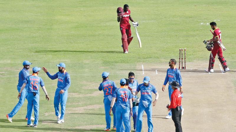 India celebrate their third ODI win against West Indies.