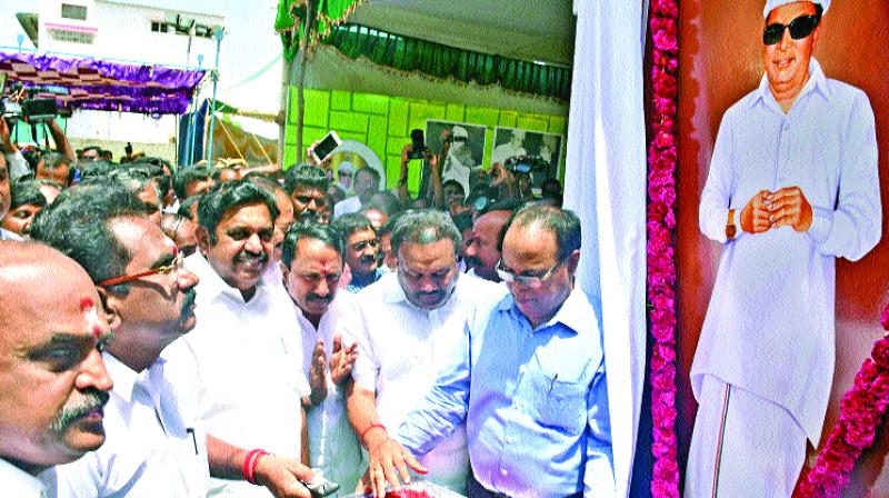 Chief Minister pays tributes with rose petals to the portrait of MGR along with party leaders and cadre.