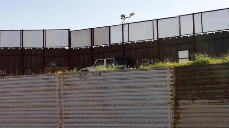 A Border Patrol vehicle sits alongside a border structure separating Tijuana, Mexico from San Diego. (Photo: AP)