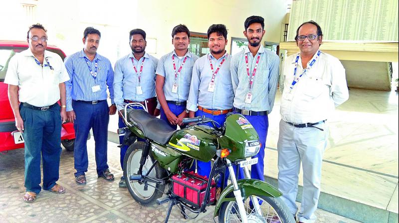 GIET students flanked by their teachers demonstrate the functioning of the electric bike on college campus in Rajahmundry on Thursday. (Photo: DC)