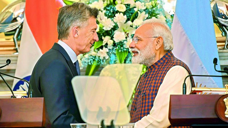 Prime Minister Narendra Modi exchanges greetings with Argentinas President Mauricio Macri after their joint press conference at Hyderabad House in New Delhi, Monday. (PTI)