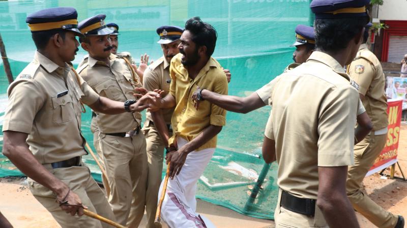 Police lathicharges a Youth Congress worker during the protest march held as a part of the hartal at Thrissur town on Monday. (ANUP K. VENU)
