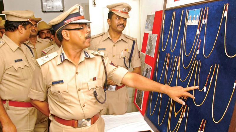 Additional Police Commissioner B.K. Singh inspects the jewelry items seized by Jayanagar police in Bengaluru on Monday (Photo: DC)