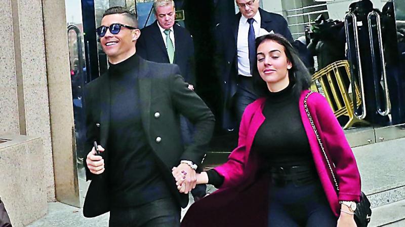 Cristiano Ronaldo leaves the court with his girlfriend Georgina Rodriguez in Madrid on Tuesday.(Photo: AP)