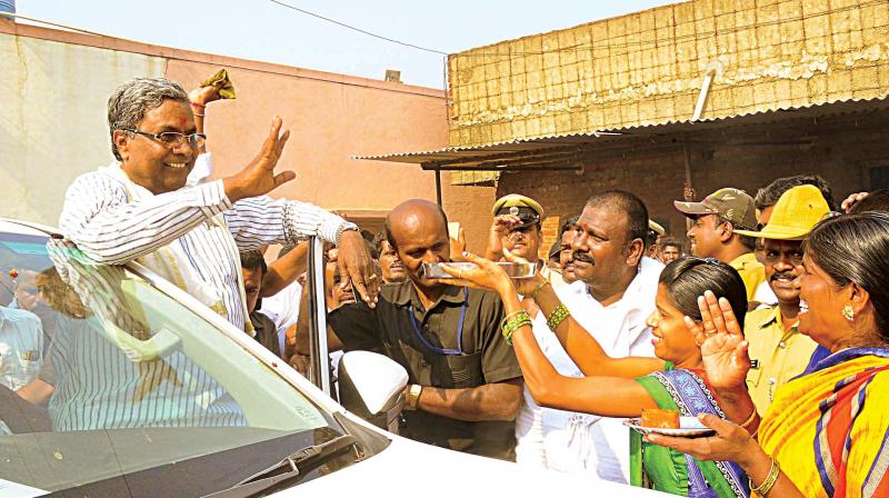 CM Siddaramaiah is greeted by locals at Chamundeswari constituency in Mysuru on Thursday 	KPN