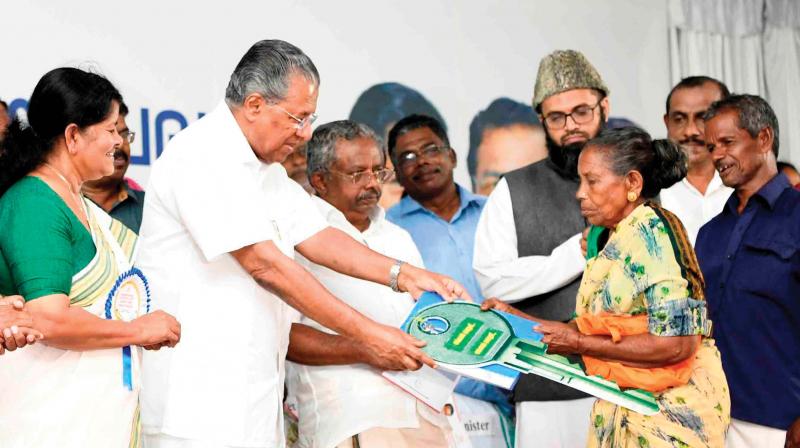 Chief Minister Pinarayi Vijayan hands over the key of a 2 BHK flat to a beneficiary at the inauguration of the apartment complex Pratheekshaat Muttathara in Thiruvananthapuram on Wednesday.