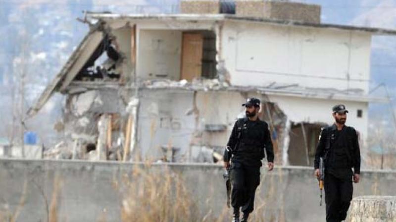 Pakistani policemen outside the Abbottabad building where Osama bin Laden was killed by US special forces in May 2011.